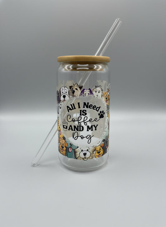 Clear glass tumbler with dog illustrations and text on a black surface