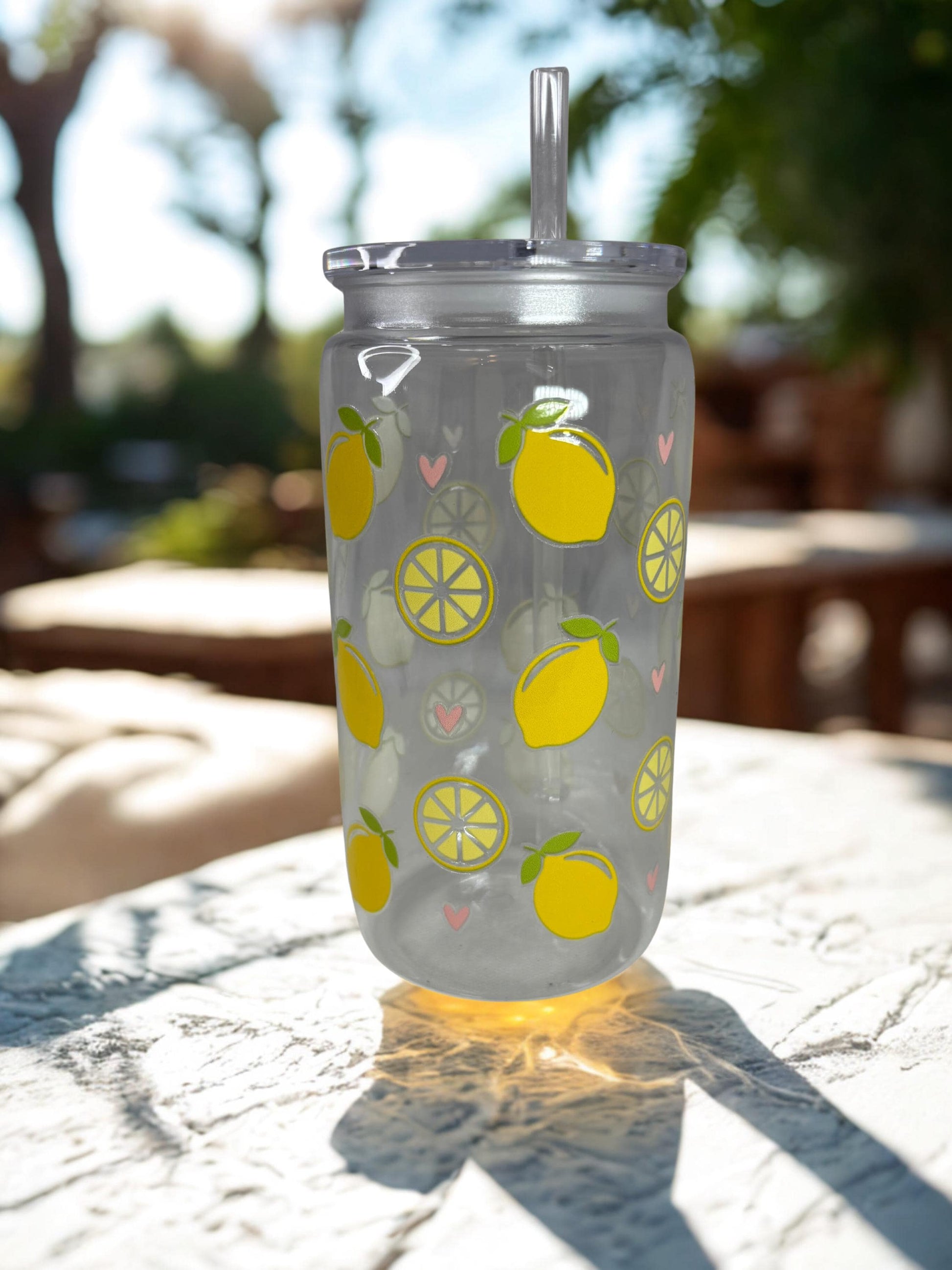 Clear tumbler with lemon pattern on a table outdoors