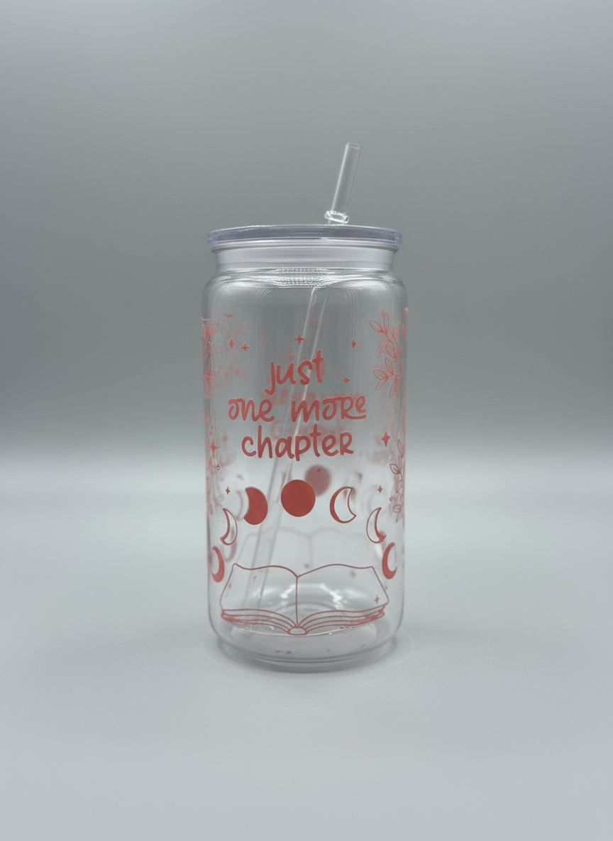 Clear tumbler with red text and moon phases on a black surface