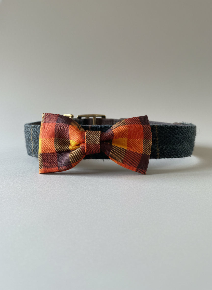 Plaid bow tie on a wooden surface with a fireplace in the background