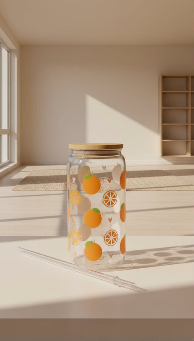 Glass with orange pattern and straw on a dark surface