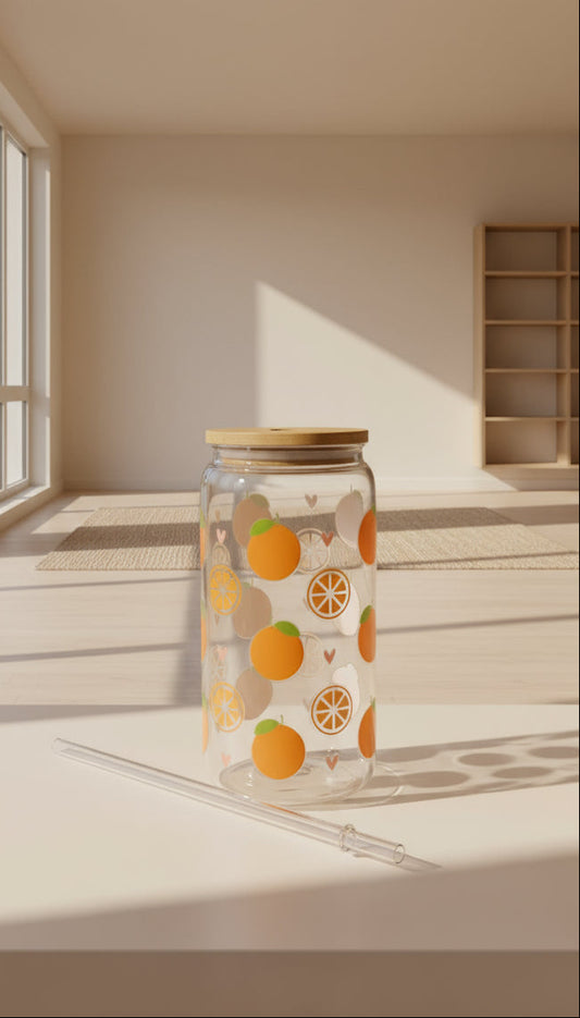 Glass with orange pattern and straw on a dark surface