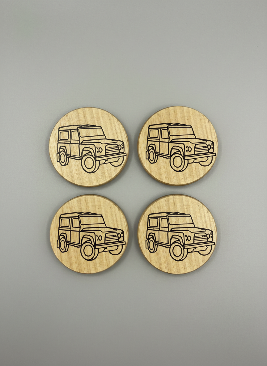 Four wooden coasters with laser-cut vehicle design on a gray background
