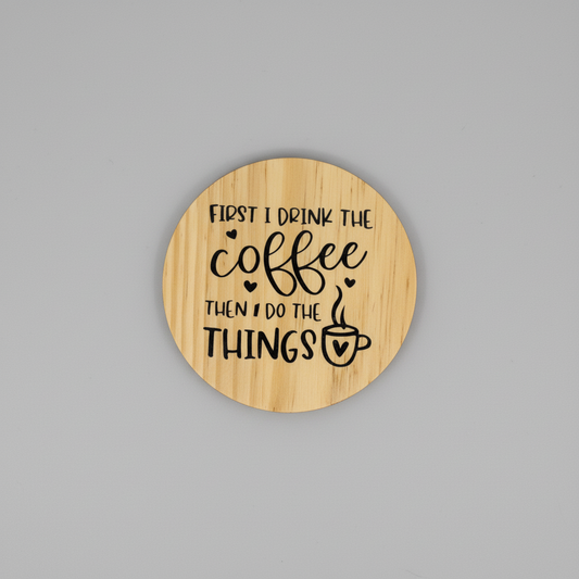 Wooden coaster with engraved text on a gray textured background