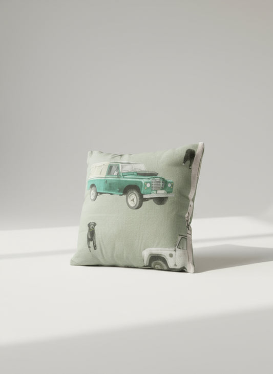 Pillow with a green truck design on a patterned sofa