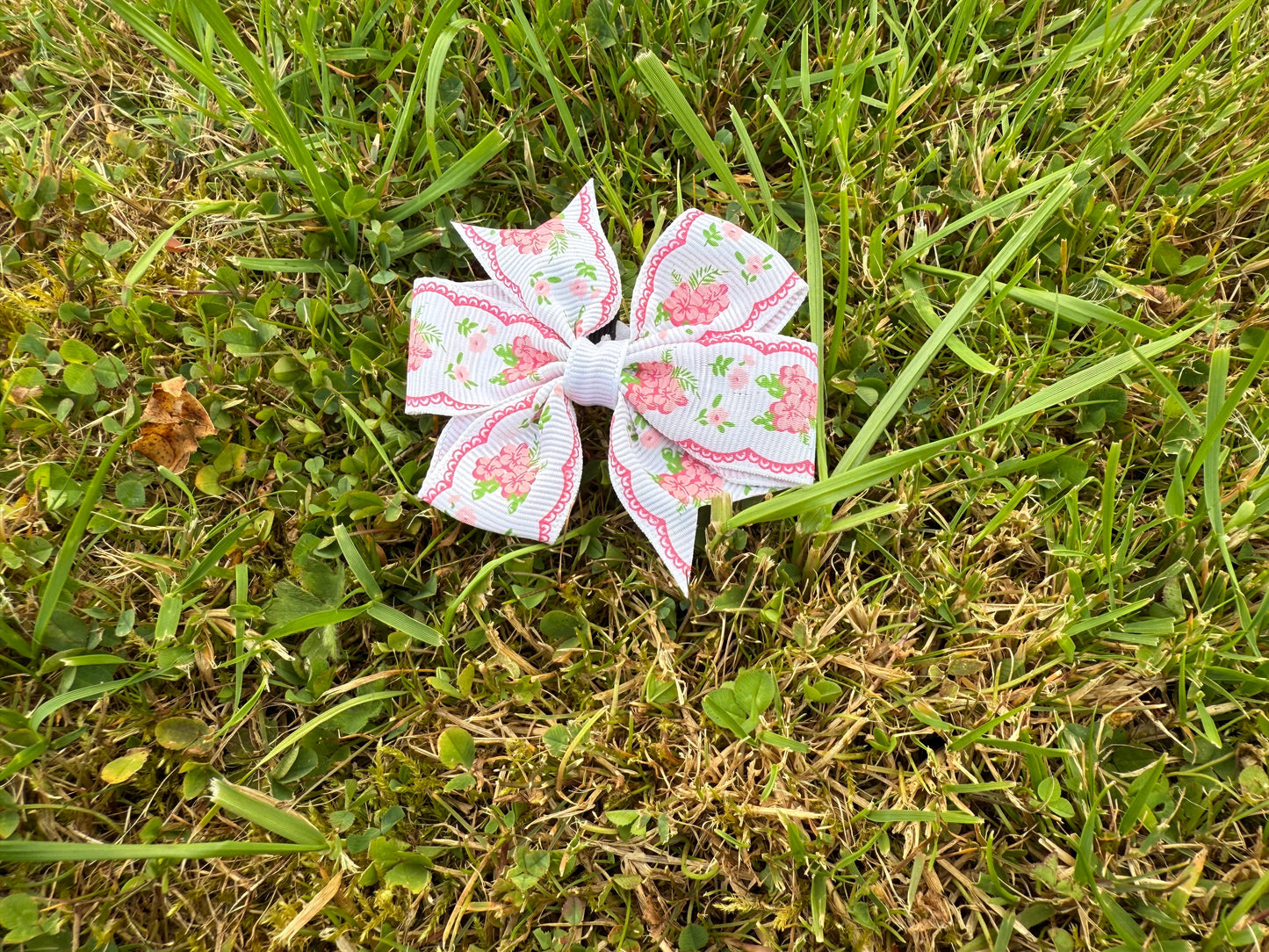 White Floral bow on grass