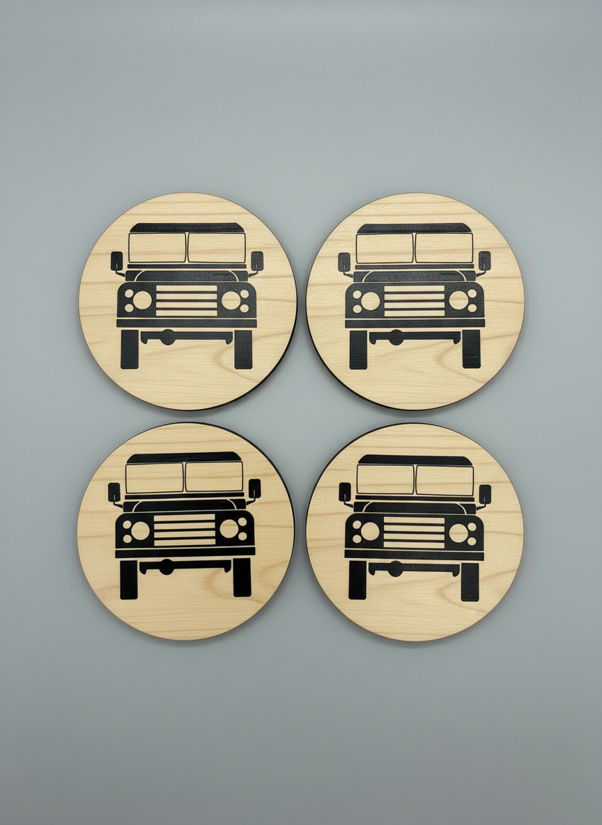 Four wooden coasters with Land Rover illustrations on a gray background