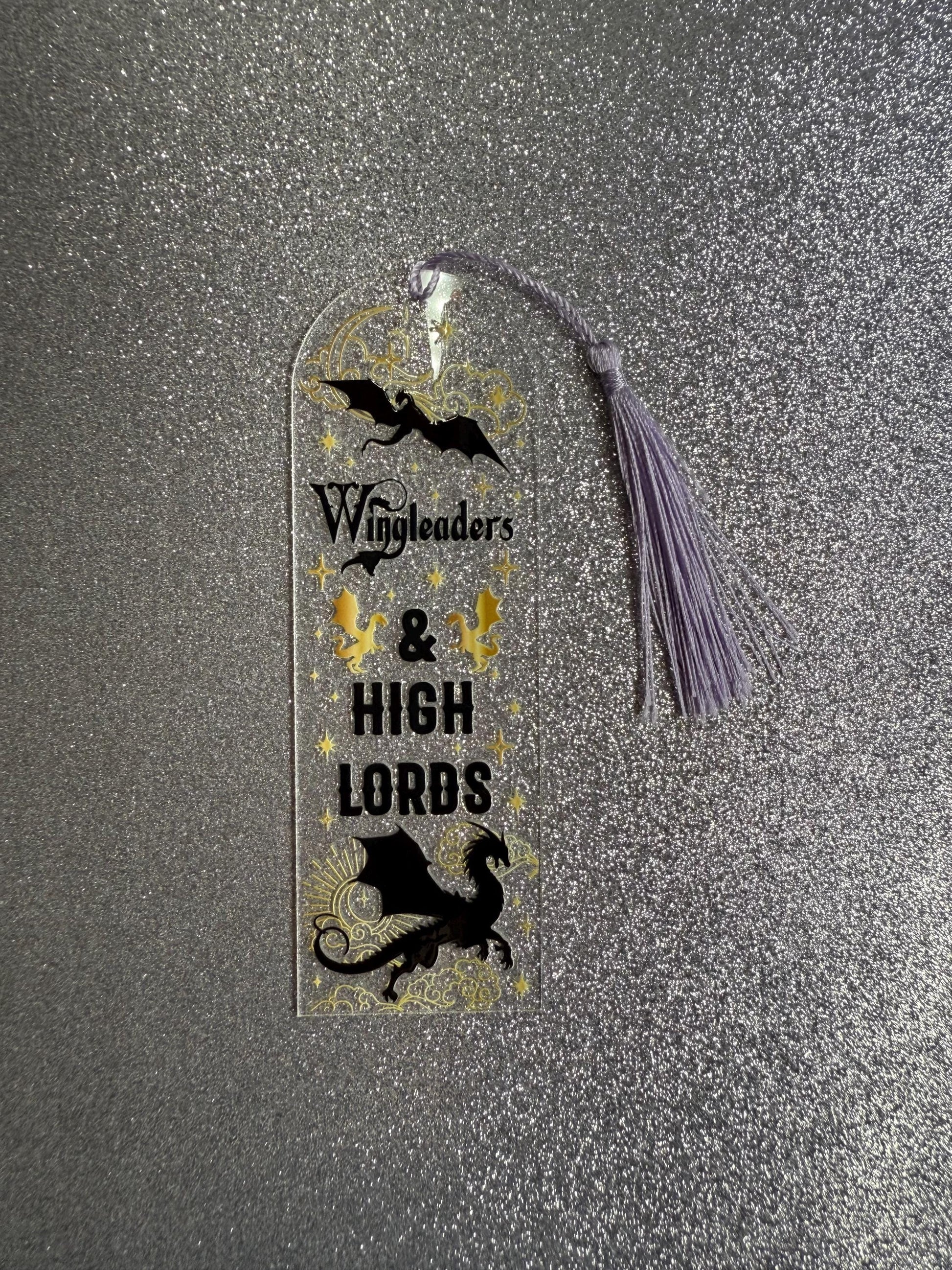 Decorative bookmark with dragons and text on a glittery surface