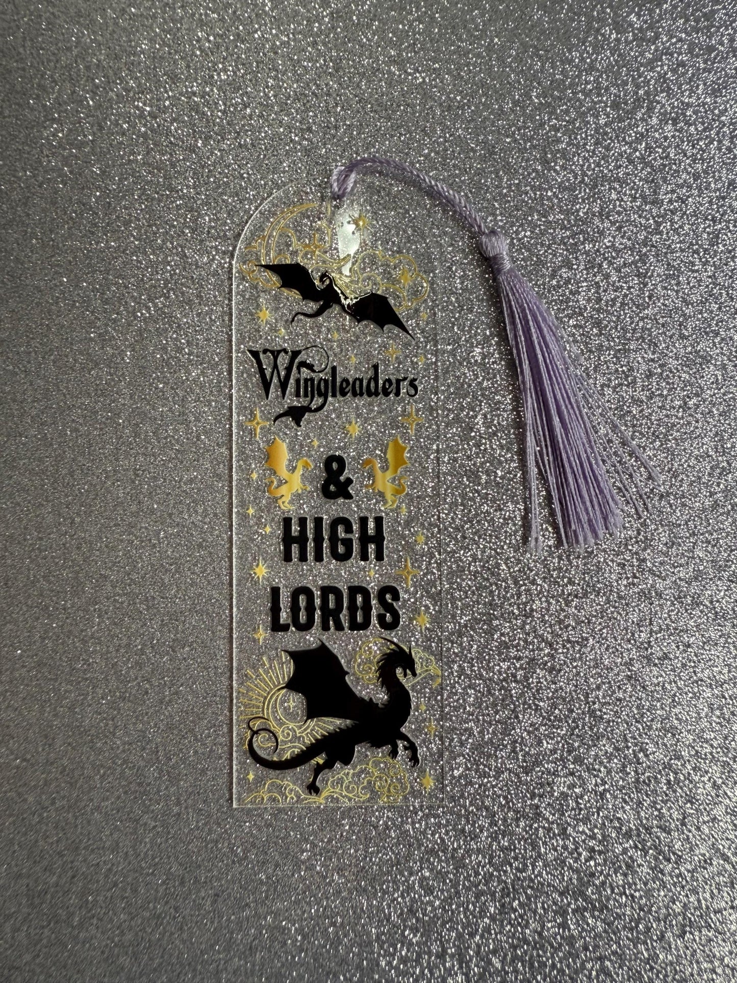 Bookmark with dragons and text on a metallic surface