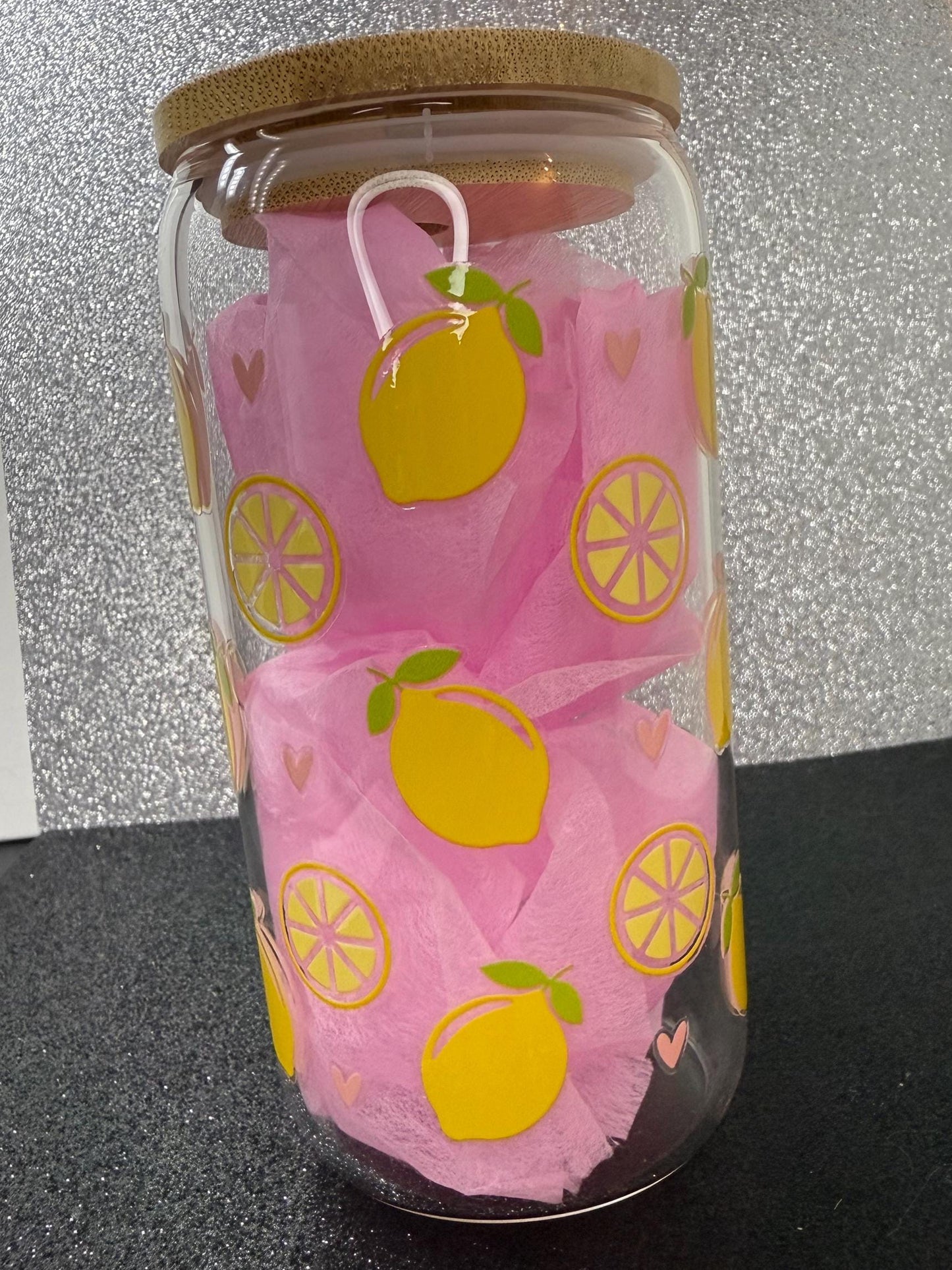 Glass with  lemon designs on a black surface