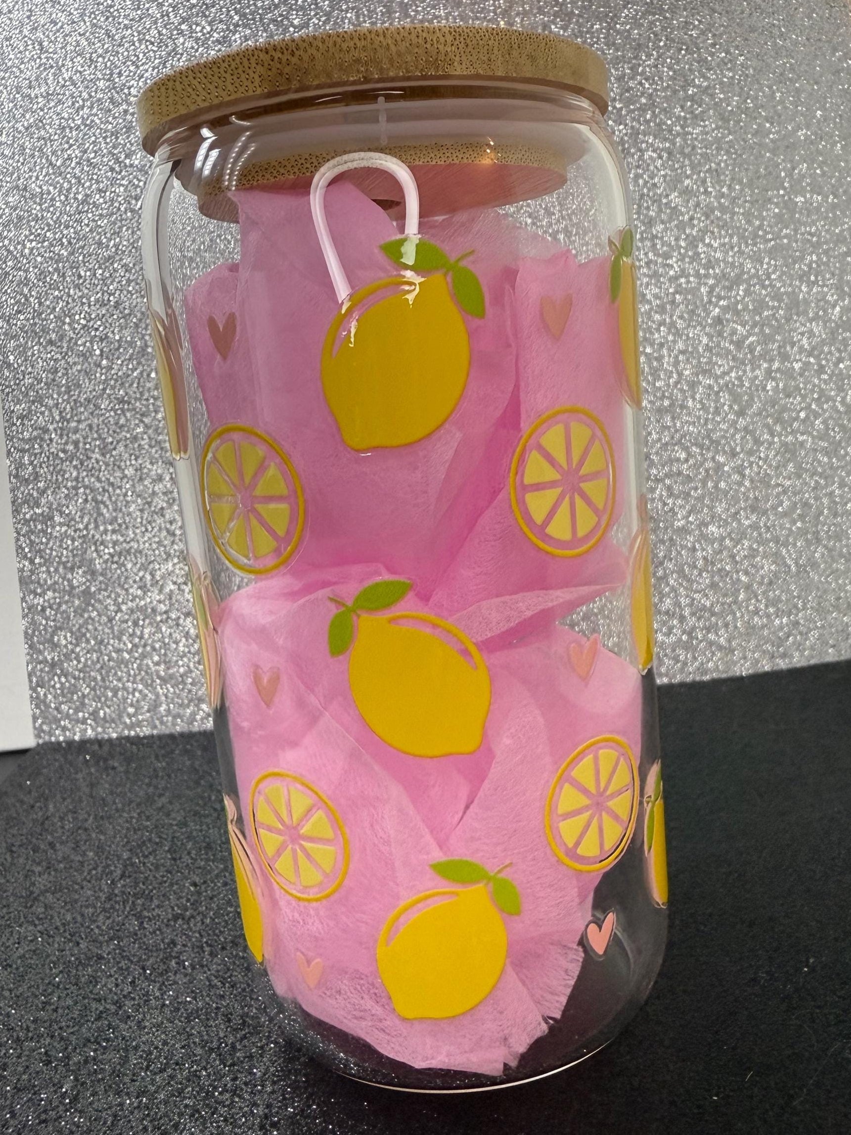 Glass with  lemon designs on a black surface