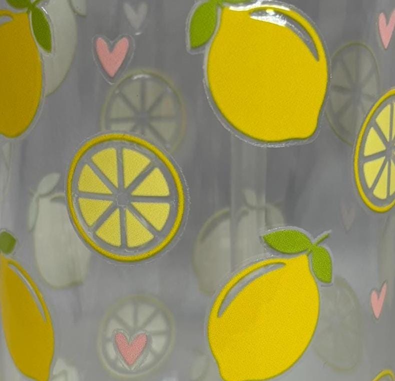 Pattern of yellow lemons and pink hearts on a gray background